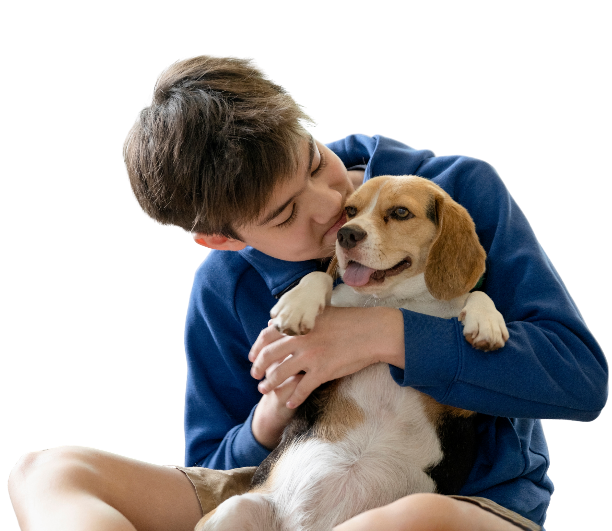 Young person affectionately kissing a beagle dog